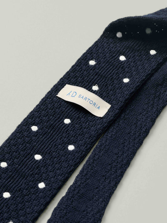 Navy blue knitted tie with white polka dots and 'AD Sartoria' label