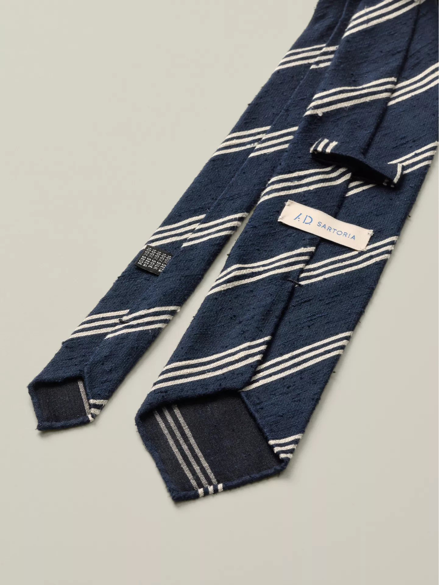 Navy & white striped tie in silk from the back.
