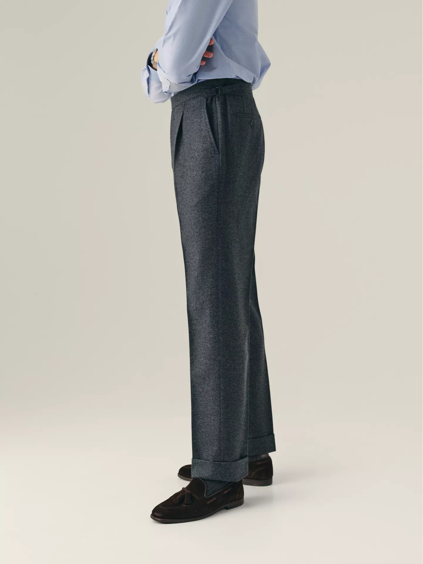 Grey Pleated trousers from the side wore with blue shirt